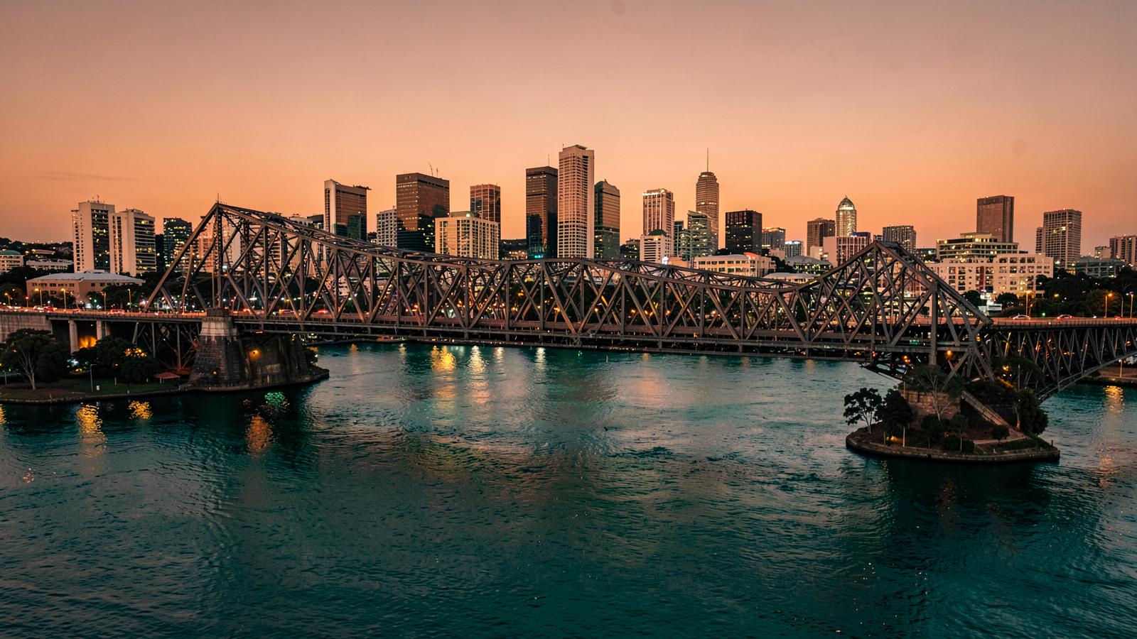 Brisbane City skyline and the Story Bridge beside the Brisbane River at dusk